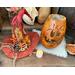 This shows Archey the pumpkin gourd sitting next to his custom witch hat and his battery operated candle. 